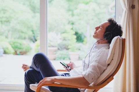 man_listening_to_music_in_zero_gravity_chair_large